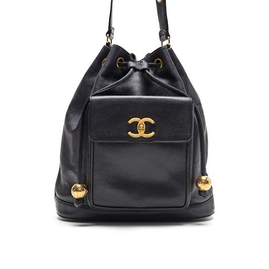 CHANEL Chain Backpack Bag, Outside Flap with Ball Charm, Drawstring, Caviar Skin, Black, Gold-Tone Hardware, Pre-Owned - Vintage La Charme