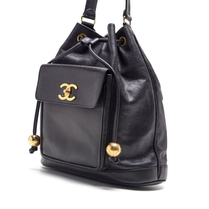 CHANEL Chain Backpack Bag, Outside Flap with Ball Charm, Drawstring, Caviar Skin, Black, Gold-Tone Hardware, Pre-Owned - Vintage La Charme