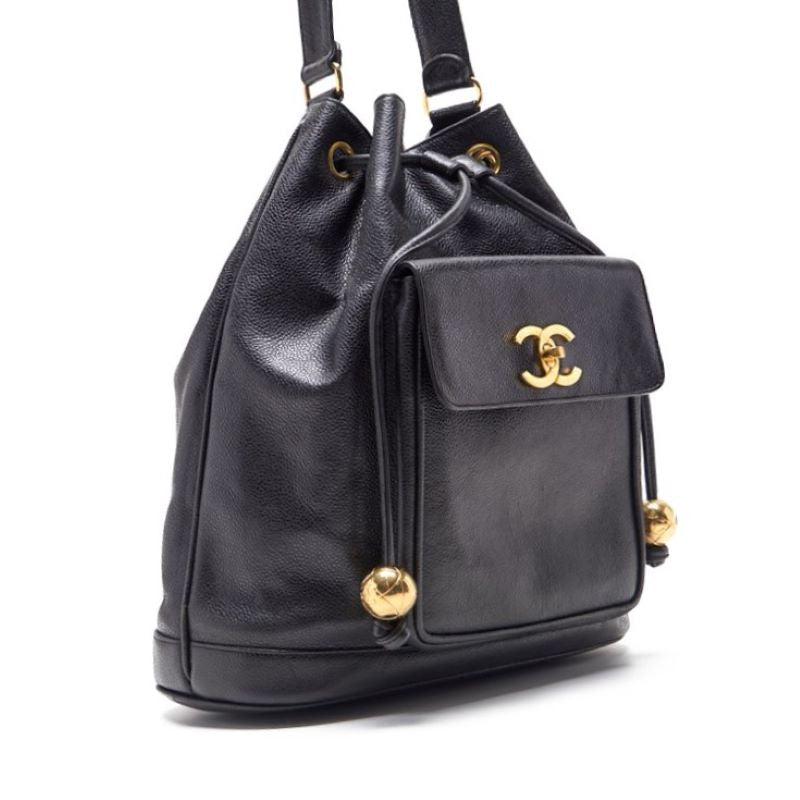 CHANEL Chain Backpack Bag, Outside Flap with Ball Charm, Drawstring, Caviar Skin, Black, Gold-Tone Hardware, Pre-Owned - Vintage La Charme