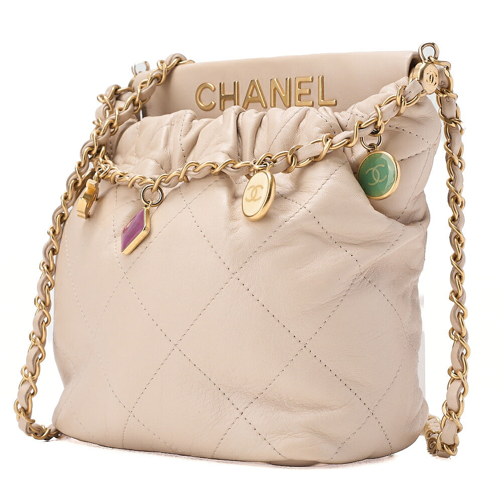 CHANEL Lambskin Matelasse with charm, drawstring style, chain shoulder, beige Gold-Tone Hardware, Pre-Owned