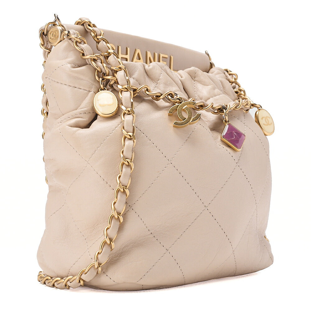 CHANEL Lambskin Matelasse with charm, drawstring style, chain shoulder, beige Gold-Tone Hardware, Pre-Owned