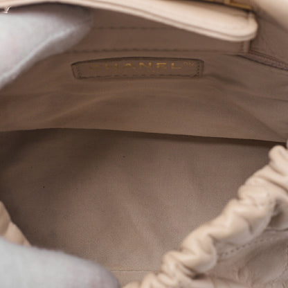 CHANEL Lambskin Matelasse with charm, drawstring style, chain shoulder, beige Gold-Tone Hardware, Pre-Owned